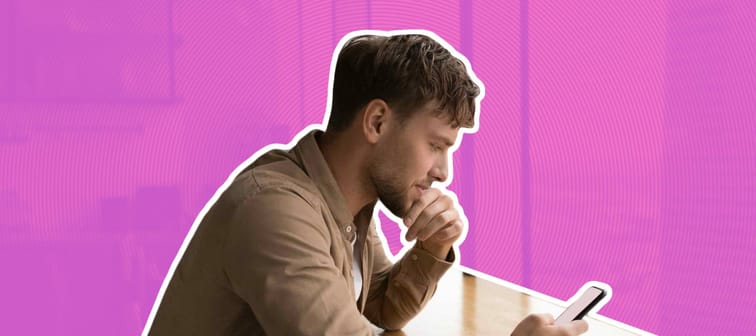 Information to think about. Pensive male look at cell ponder on job offer received by email. Young businessman sit by large window at modern kitchen, read important message on phone screen