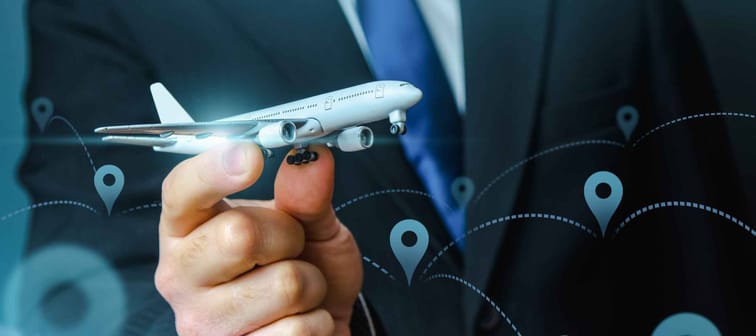 A plane taking off in the hands of a businessman and a pin location symbol. Business tourism. Organization of air traffic. Business class flights. Support financial program for civil aviation