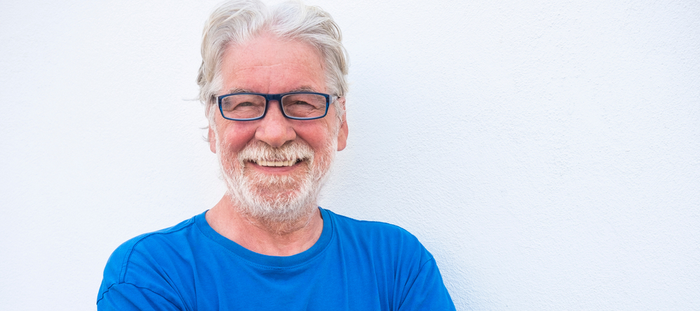 Retired older man smiling at the camera