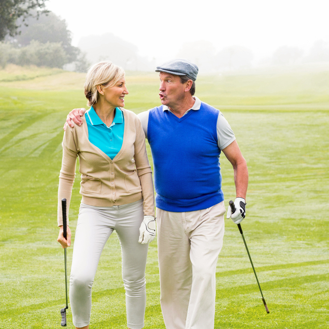 Retired couple chatting while on the golf course