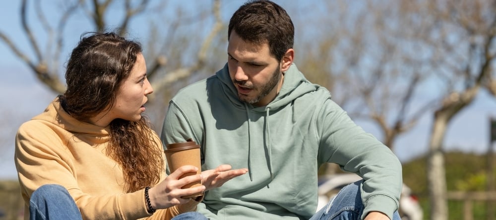 Couple in a park in a heated discussion.