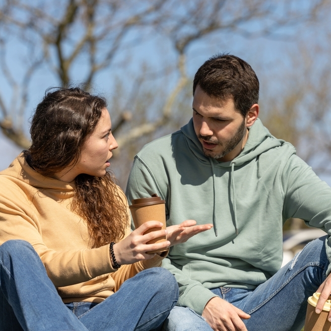 Couple in a park in a heated discussion.