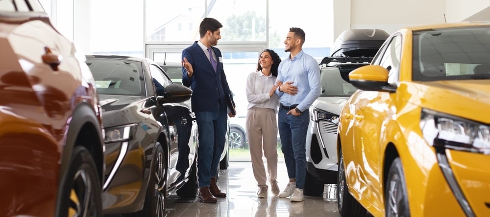 Photo of a couple at a car dealership
