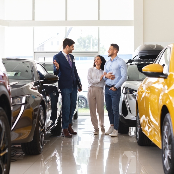 Photo of a couple at a car dealership