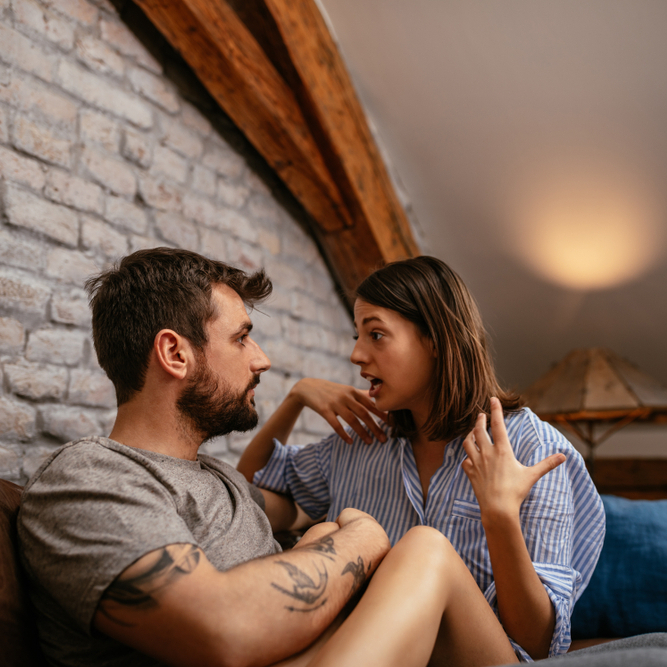 A young couple having a serious discussion at home