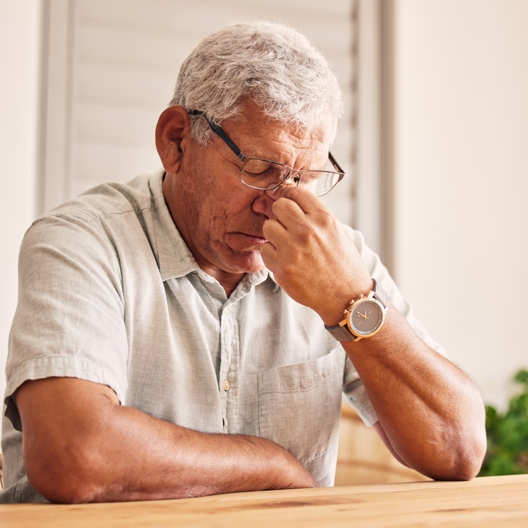 Worried retiree man sitting thinking.