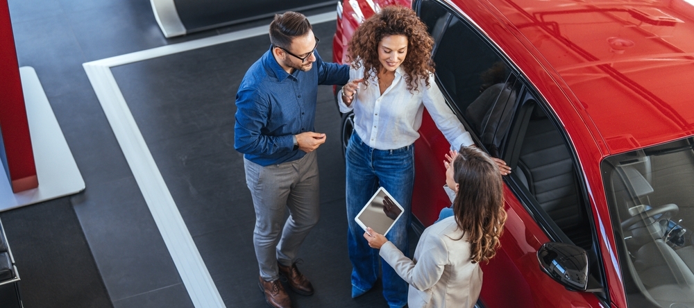 Photo of a couple at a car dealership