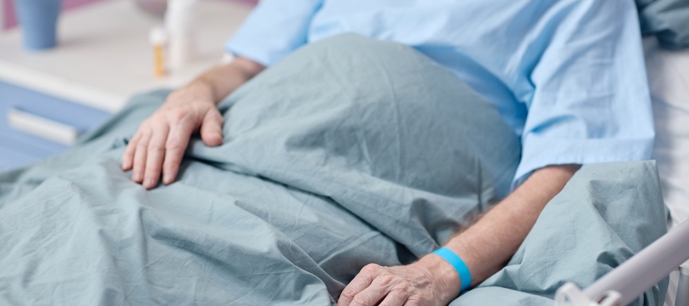 Senior man in hospital bed