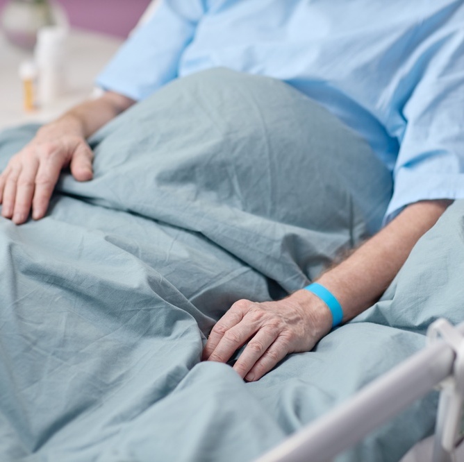 Senior man in hospital bed
