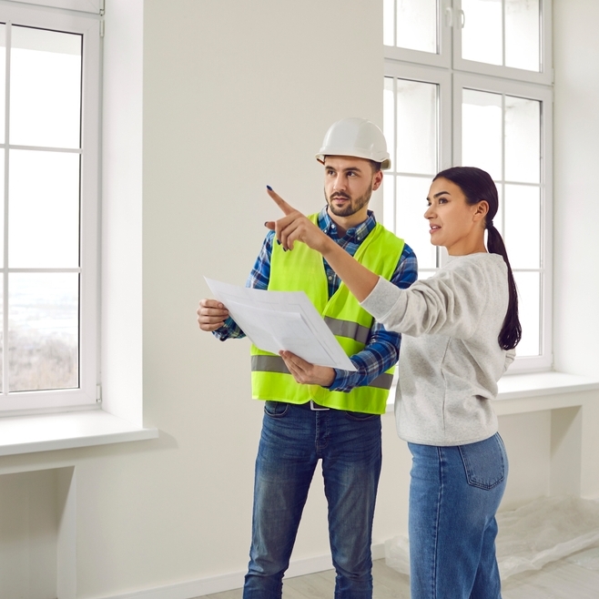 Woman with male construction contractor