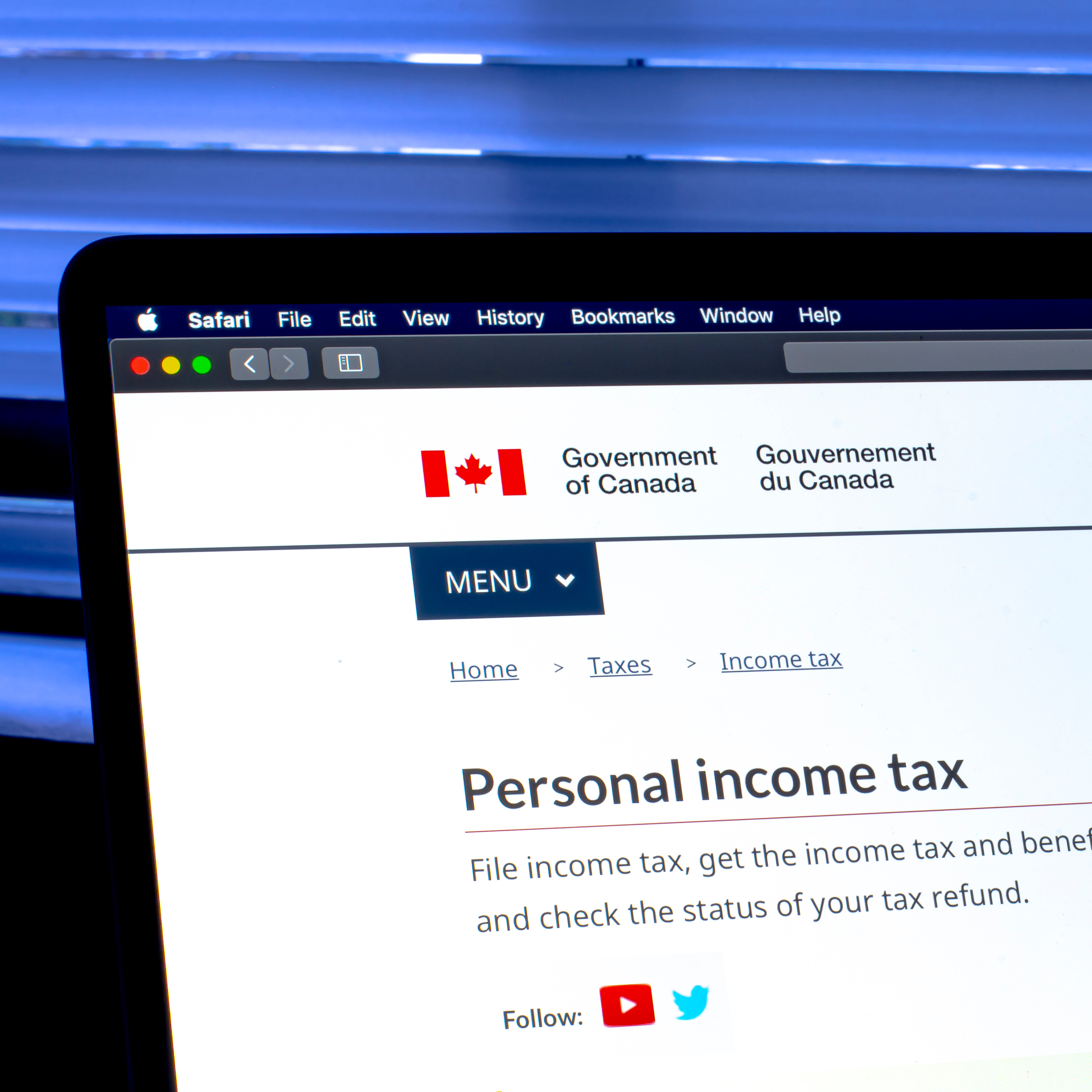 A laptop with the Government of Canada tax revenue website on the screen.