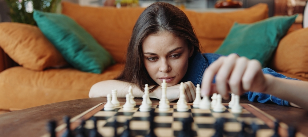 Young woman playing chess