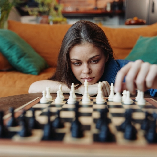 Young woman playing chess