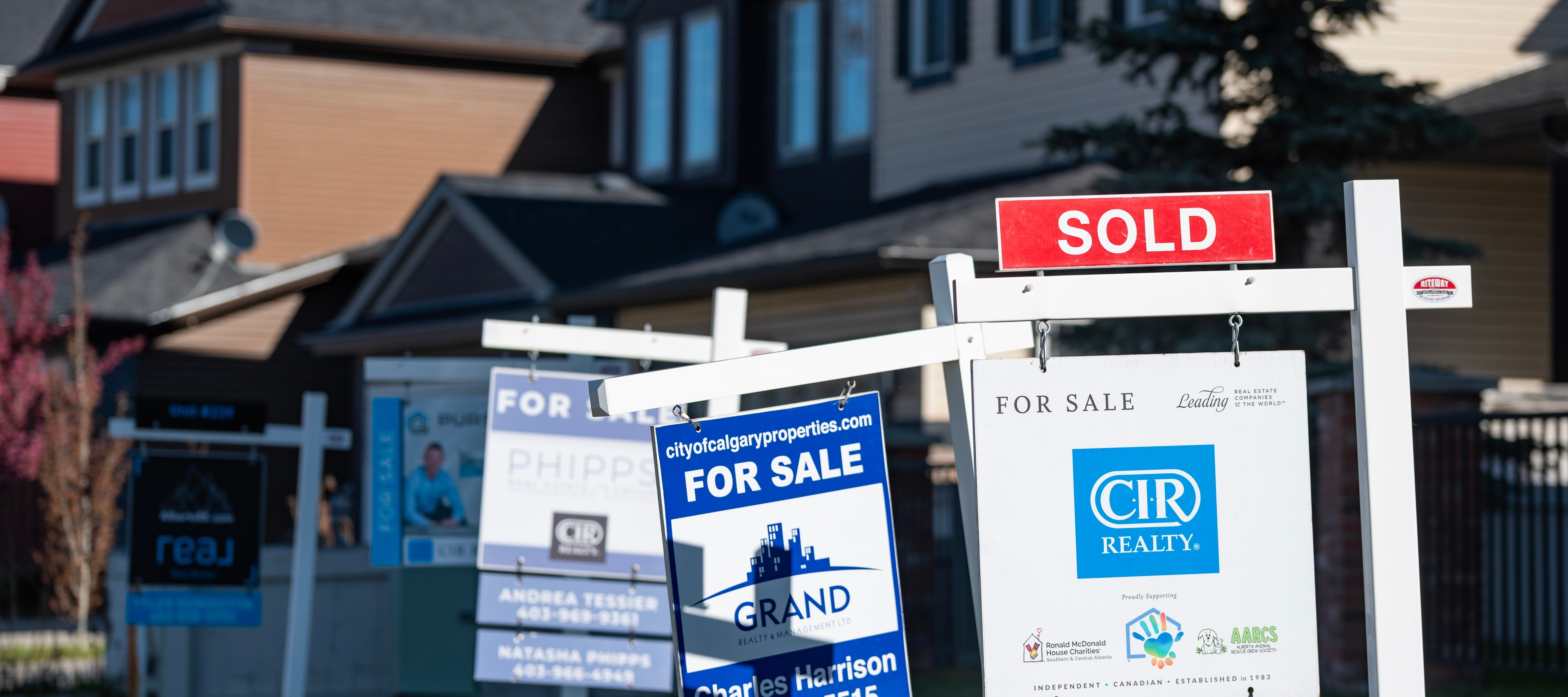 Real estate signs were photographed in Calgary, Alberta. May 2025