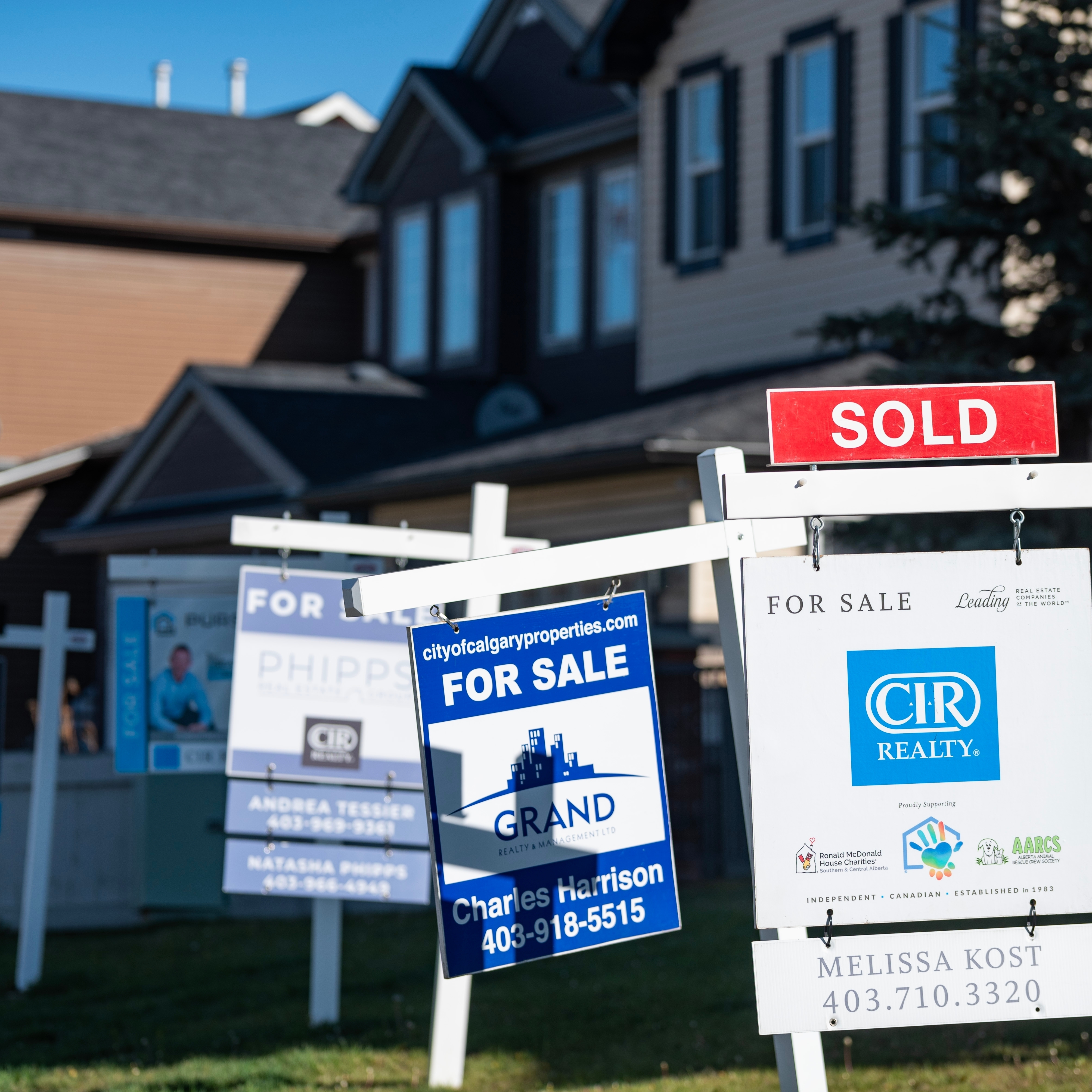 Real estate signs were photographed in Calgary, Alberta. May 2025