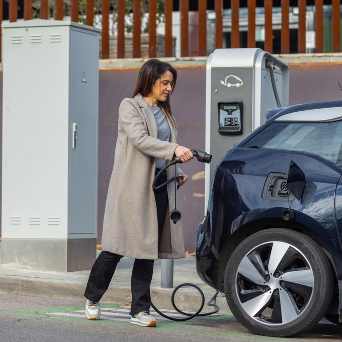 Woman charging EV
