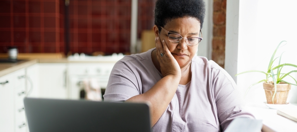 Middle-aged black woman reviewing financial documents