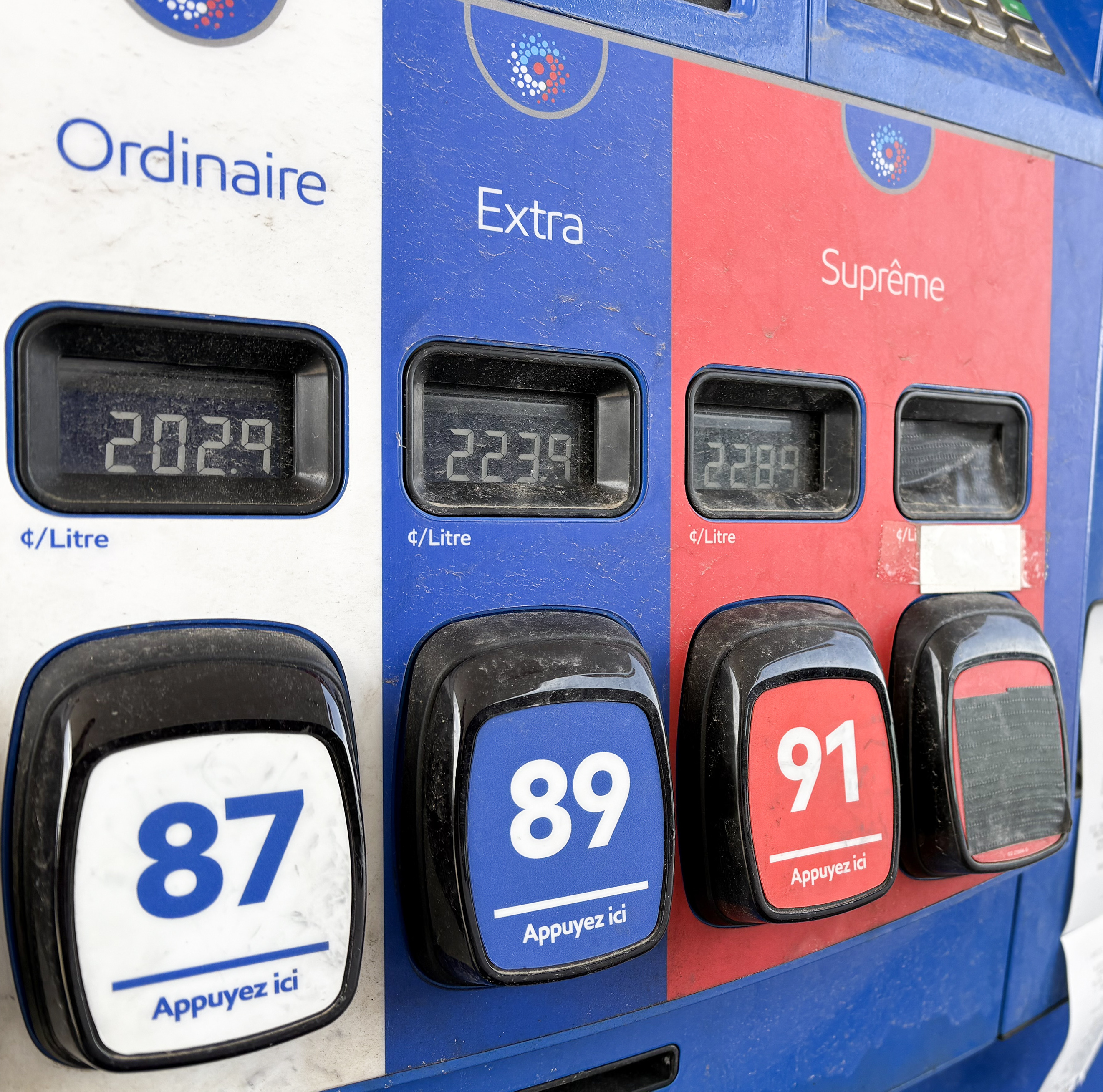 Gas pumps showcasing high prices