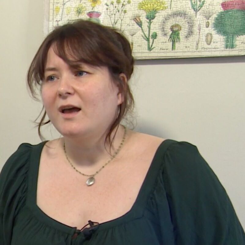 Woman being interviewed on TV in her home