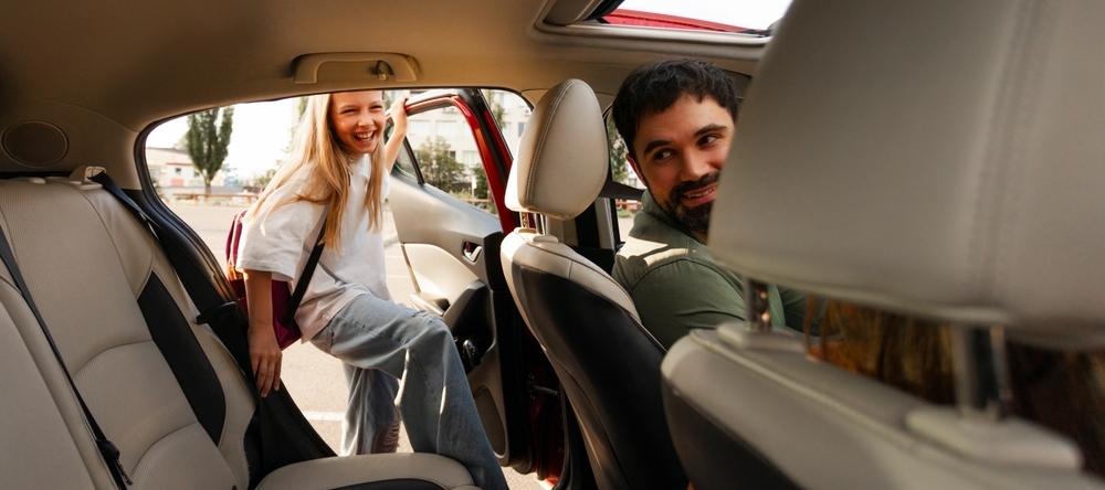 Daughter getting into her dad's car