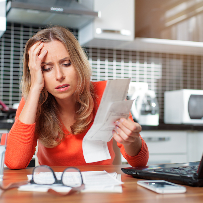 Stressed woman reviewing finances