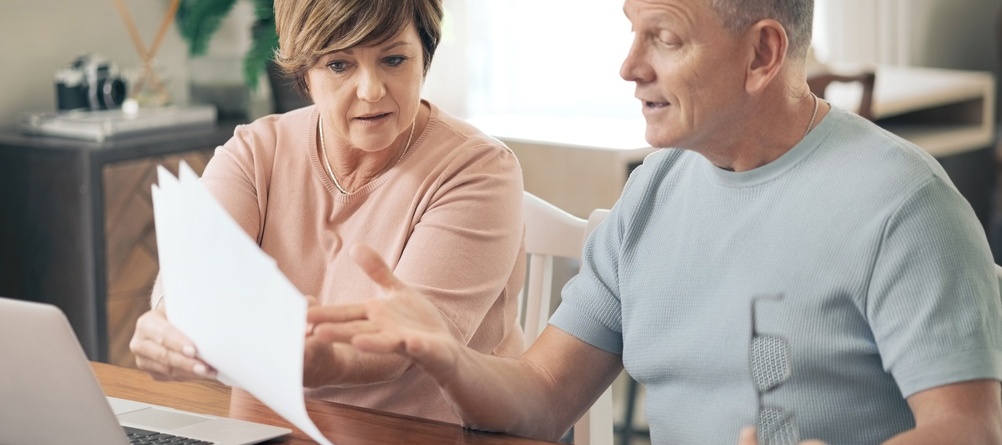 Couple discussing finances looking stressed