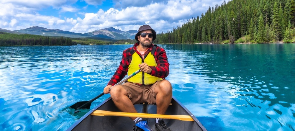 Man paddling on lake