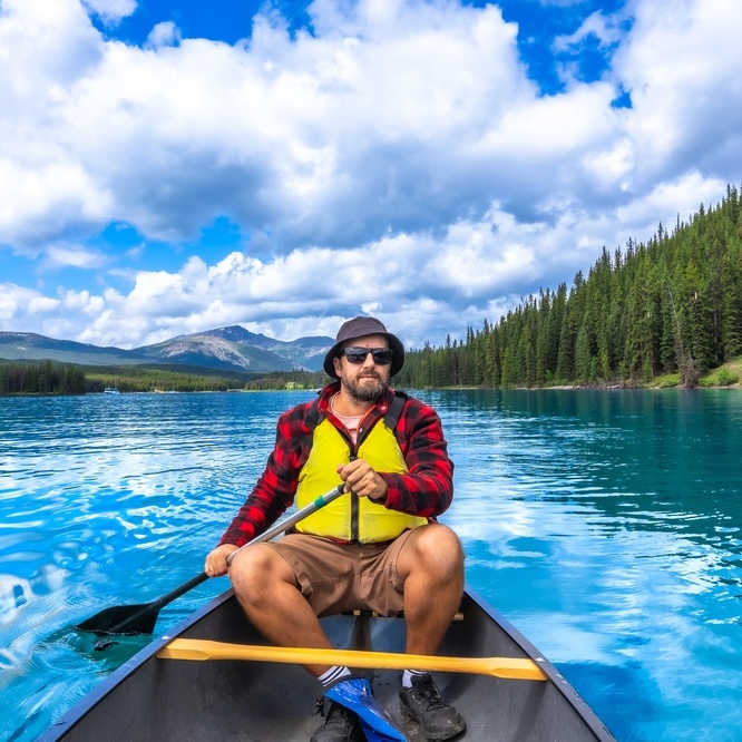 Man paddling on lake