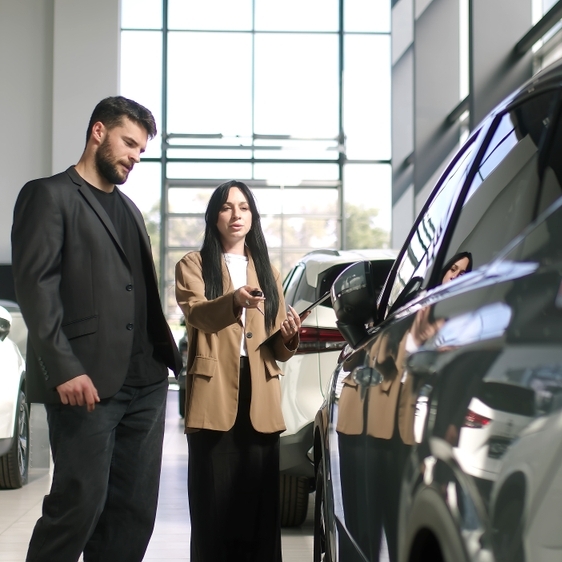 A man buying a car off a female car salesperson