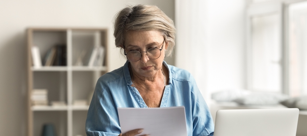 Retired woman looking at papers