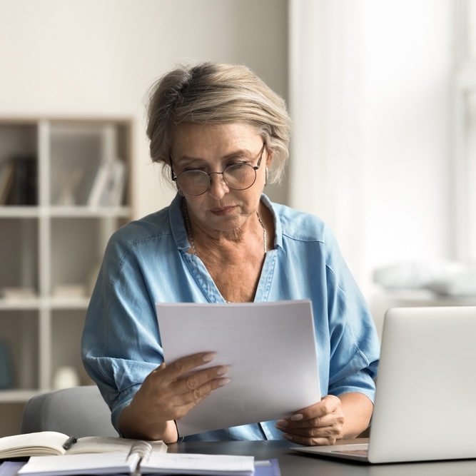Retired woman looking at papers