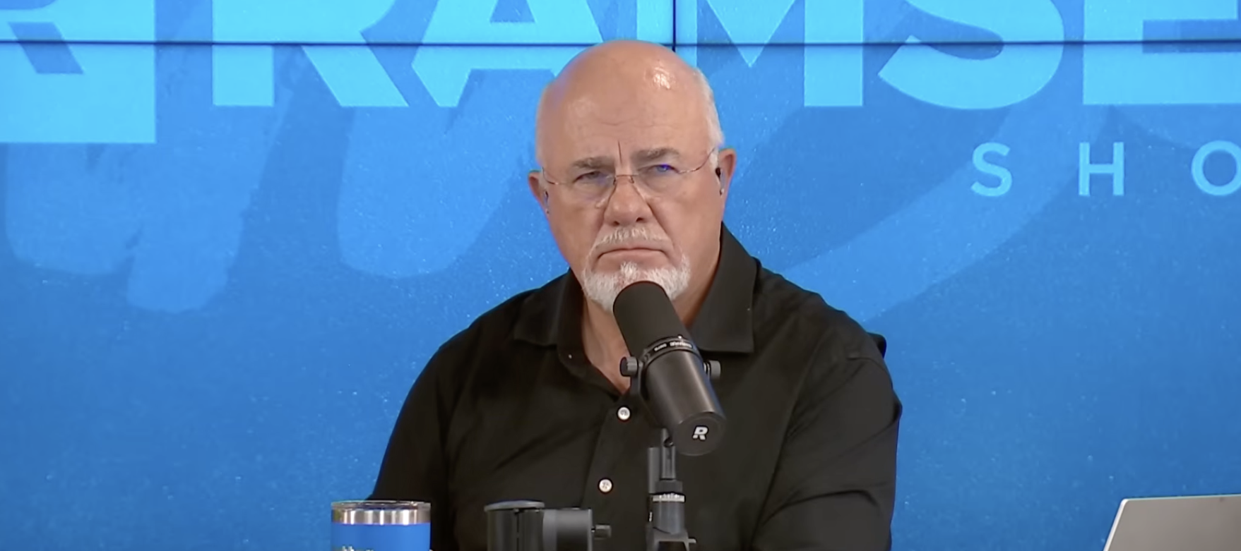 Dave Ramsey sitting at a desk