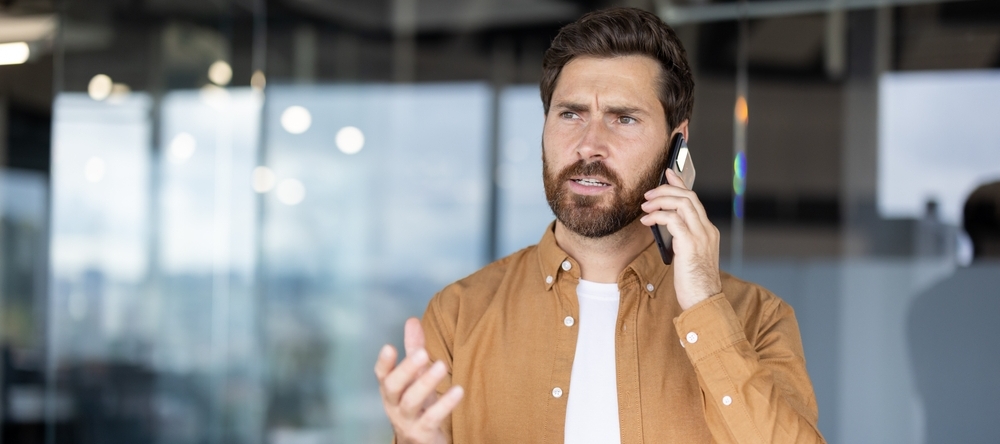 A phone on the phone looking concerned