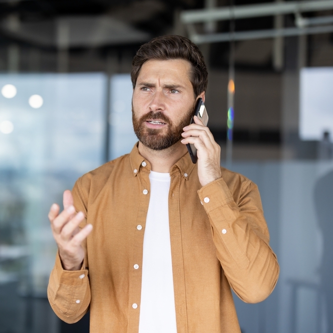 A phone on the phone looking concerned