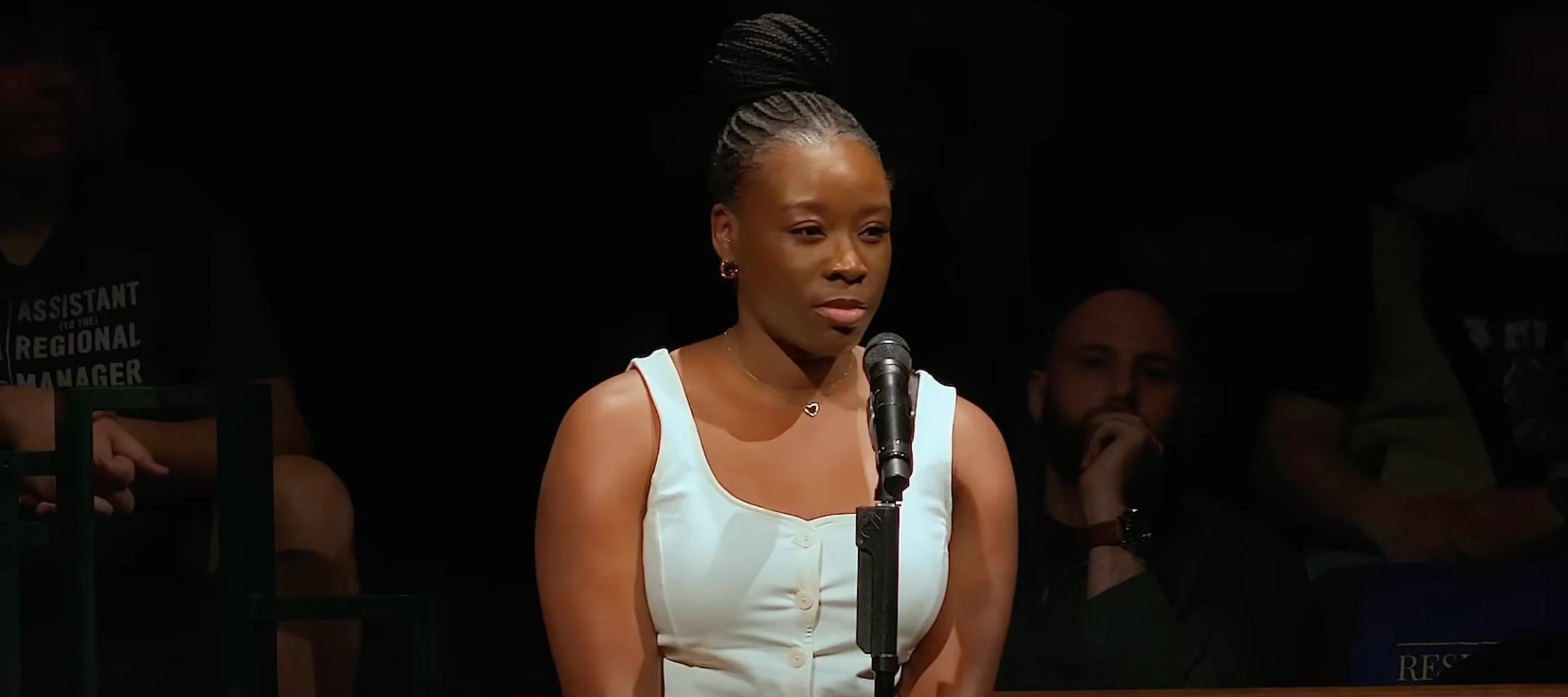 Woman standing at a microphone