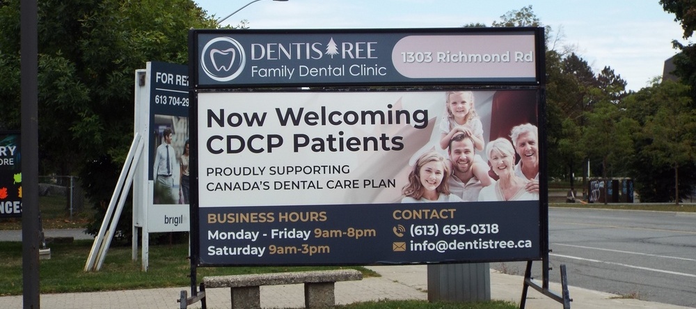 A roadside promotional sign for "DentisTree Family Dental Clinic" announces its acceptance of CDCP patients and lists business hours on Richmond Rd in Ottawa, Canada
