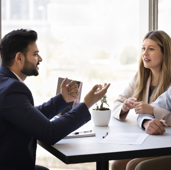 A married couple sitting and chatting with a financial advisor