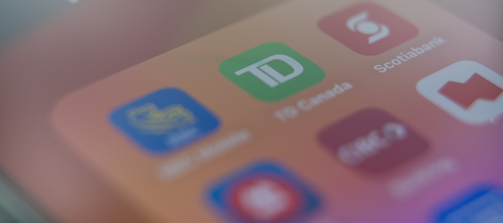 Mobile applications of popular banks in Canada. Bank applications on phone screen.