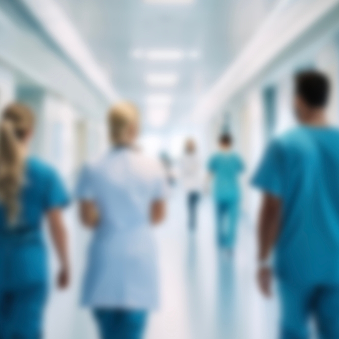 Blurry image of nurses walking down a hospital corridor