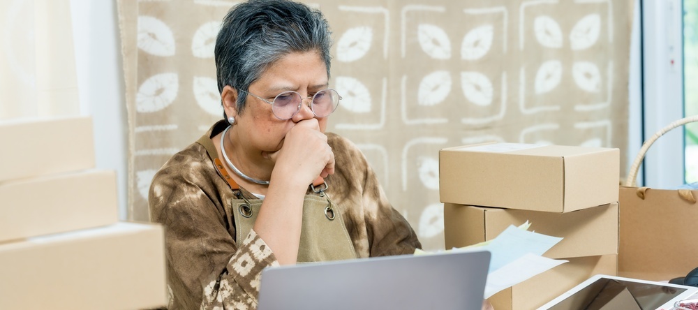 Senior asian woman entrepreneur looking at the business books