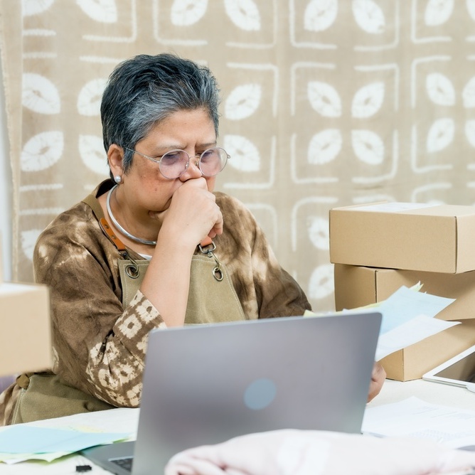 Senior asian woman entrepreneur looking at the business books
