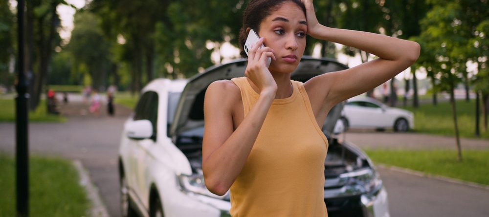 Woman in a car accident calling insurance