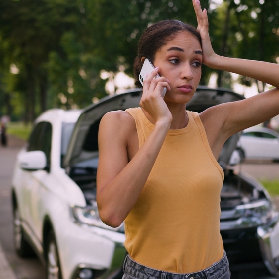 Woman in a car accident calling insurance