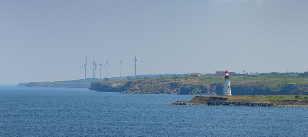 Low Point lighthouse with New Waterford wind turbines on Cape Breton Island Nova Scotia