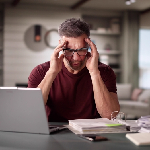 Mature man doing tax and budget. Financial overload and debt
