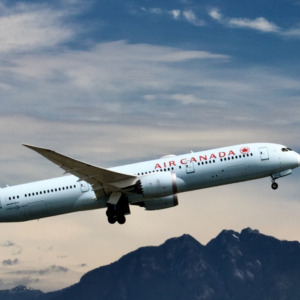 Air Canada commercial airliner taking off, Collage Gold price analysis with upward trends and financial symbols.