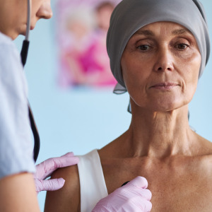 Image of a woman with cancer getting a check up