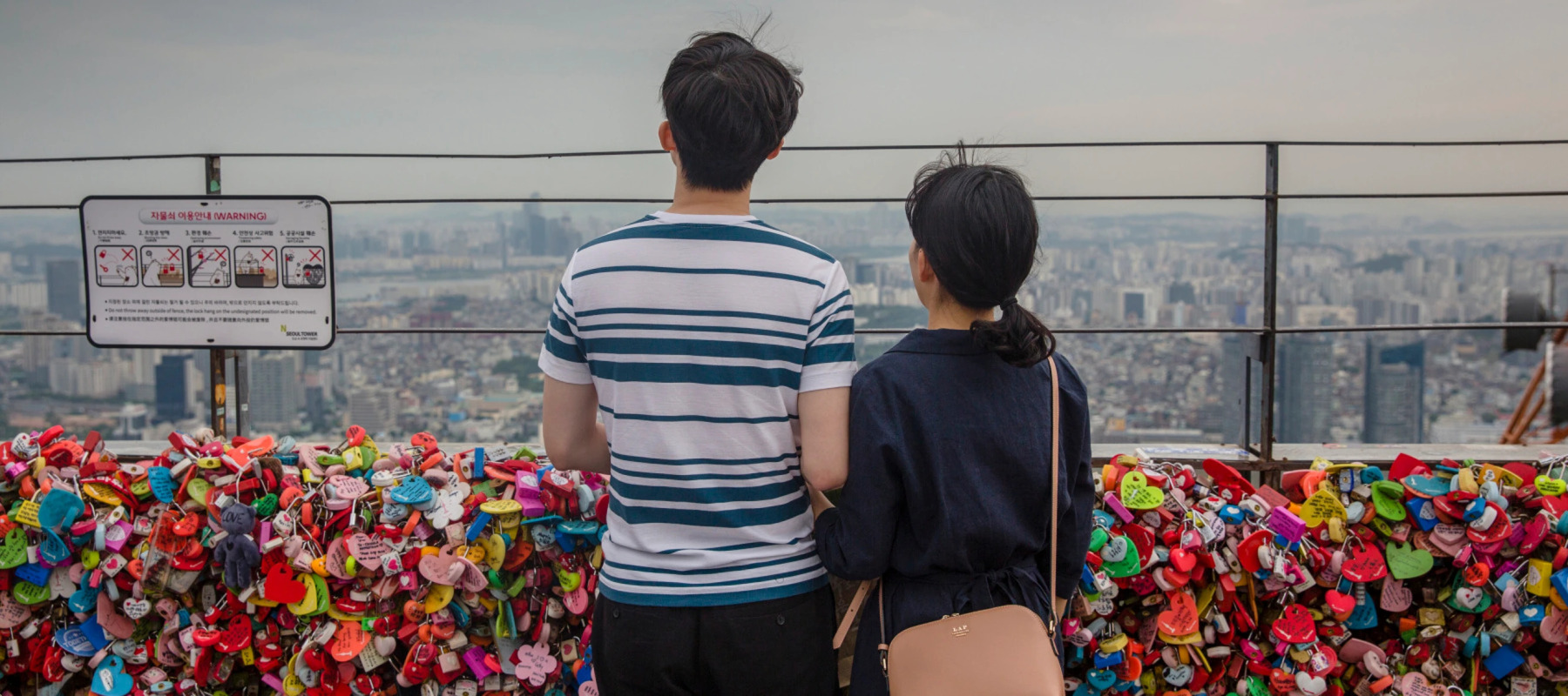 Couple standing in front of bridge