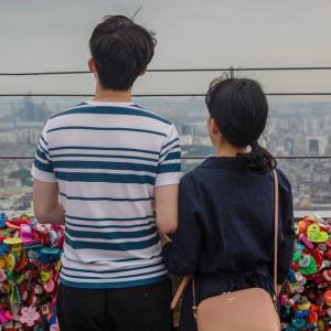 Couple standing in front of bridge