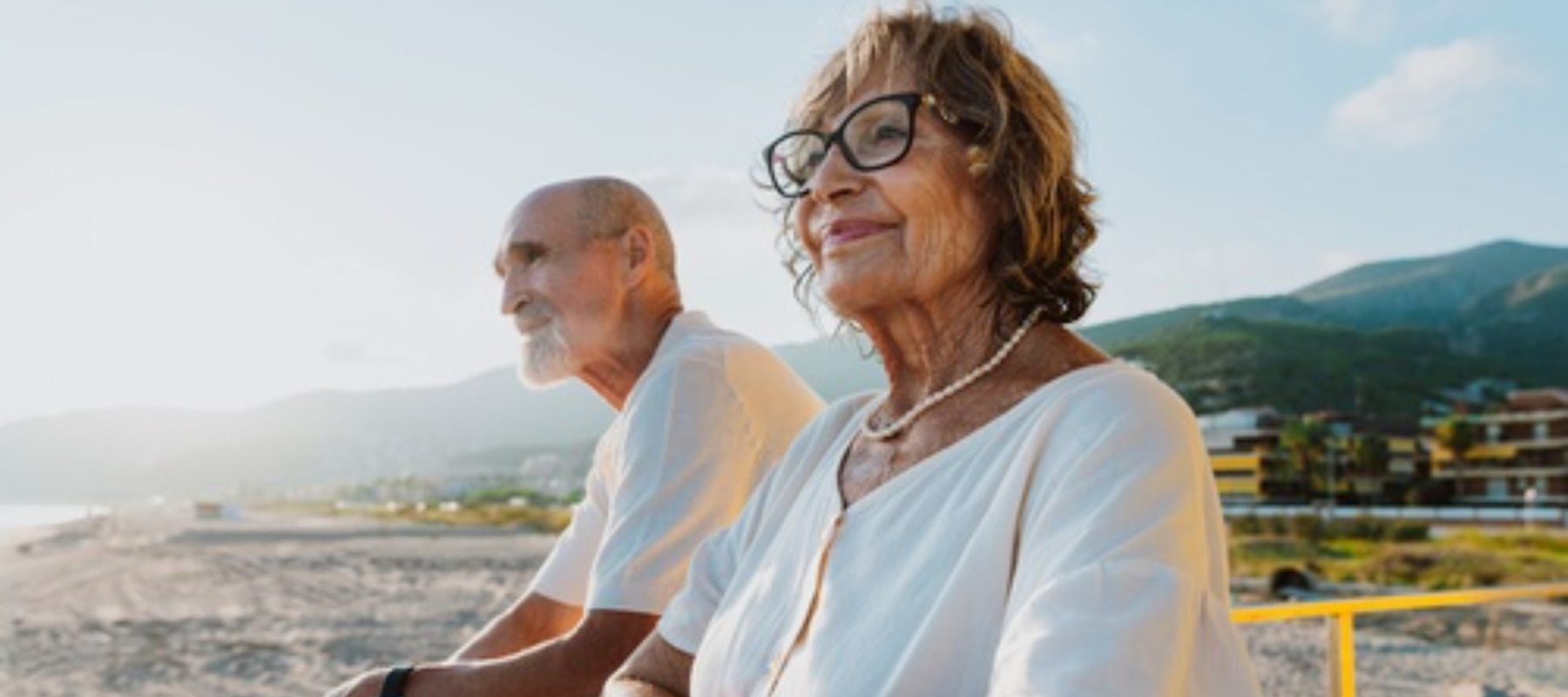 Elderly couple standing watching the sunrise